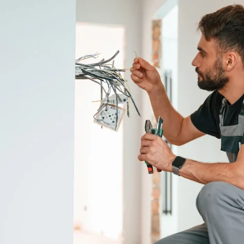 close up view electrician is working with wires i 2026 01 08 23 29 13 utc