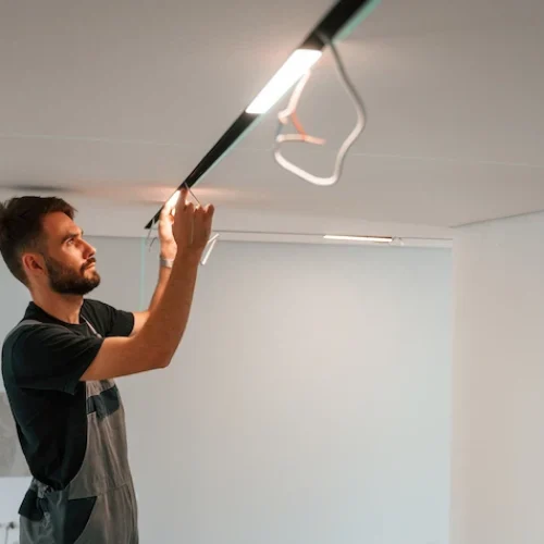 man installing modern lighting fixtures in new hou 2026 01 09 00 27 26 utc