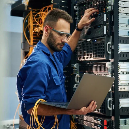 technician working on servers with laptop in hand 2026 01 09 00 24 06 utc